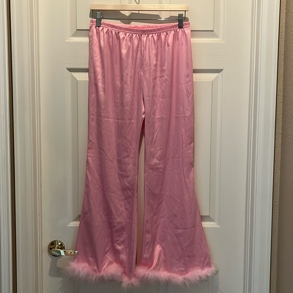 Pink silky pajama bottoms with feathered bottoms.